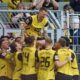 Dortmund's Marcus Reus, top, celebrates after scoring their side's second goal of the game during the Bundesliga soccer match between Borussia Dortmund and SV Darmstadt 98 at the Signal Iduna Park in Dortmund, Germany, Saturday May 18, 2024. (Bernd Thissen/dpa via AP)