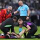 Bayern's Aleksandar Pavlovic receives treatment from medical staff during the Champions League semifinal second leg soccer match between Real Madrid and Bayern Munich at the Santiago Bernabeu stadium in Madrid, Spain, Wednesday, May 8, 2024. (AP Photo/Manu Fernandez)