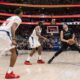 Dallas Mavericks guard Luka Doncic (77) steps back to take a shot in front of Los Angeles Clippers guard James Harden, center, as guard Norman Powell (24) looks on during the second half of an NBA basketball first-round playoff series Friday, May 3, 2024, in Dallas. (AP Photo/Jeffrey McWhorter)