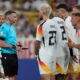 Referee Michael Oliver of England speaks with the Germany players during a round of sixteen match at the Euro 2024 soccer tournament against Denmark in Dortmund, Germany, Saturday, June 29, 2024. (AP Photo/Darko Vojinovic)