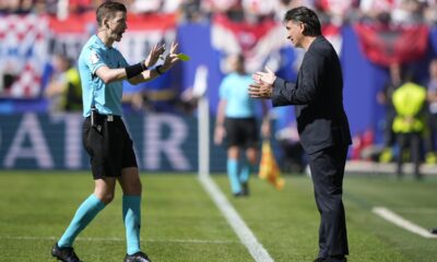 Croatia's head coach Zlatko Dalic, right, talks to French referee Francois Letexier during a Group B match between Croatia and Albania at the Euro 2024 soccer tournament in Hamburg, Germany, Wednesday, June 19, 2024. The match ended in a 2-2 draw. (AP Photo/Ebrahim Noroozi)