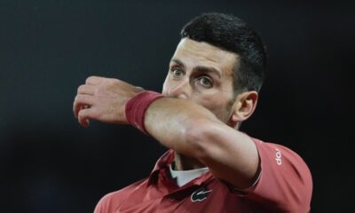 Serbia's Novak Djokovic wipes his face in his third round match of the French Open tennis tournament against Italy's Lorenzo Musetti at the Roland Garros stadium in Paris, Saturday, June 1, 2024. (AP Photo/Thibault Camus)