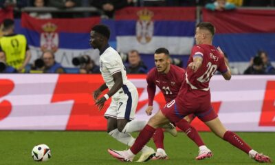 England's Bukayo Saka, left, controls the ball away from Serbia's Filip Kostic, and teammate Sergej Milinkovic-Savic during a Group C match between Serbia and England at the Euro 2024 soccer tournament in Gelsenkirchen, Germany, Sunday, June 16, 2024. (AP Photo/Frank Augstein)