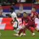 England's Bukayo Saka, left, controls the ball away from Serbia's Filip Kostic, and teammate Sergej Milinkovic-Savic during a Group C match between Serbia and England at the Euro 2024 soccer tournament in Gelsenkirchen, Germany, Sunday, June 16, 2024. (AP Photo/Frank Augstein)