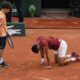 A ball kid came to the aid of Serbia's Novak Djokovic after he slipped and fell during his fourth round match of the French Open tennis tournament against Argentina's Francisco Cerundolo at the Roland Garros stadium in Paris, Monday, June 3, 2024. (AP Photo/Christophe Ena)
