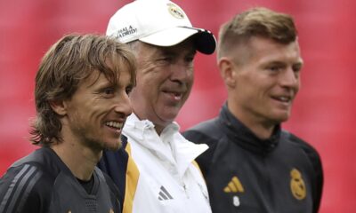 Real Madrid's Luka Modric, from left, Real Madrid's head coach Carlo Ancelotti and Real Madrid's Toni Kroos stand together during a training session ahead of the Champions League final soccer match between Borussia Dortmund and Real Madrid at Wembley Stadium in London, Friday, May 31, 2024.(AP Photo/Ian Walton)