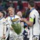 Real Madrid's Luka Modric, left, holds the trophy next to Nacho after winning the Champions League final soccer match between Borussia Dortmund and Real Madrid at Wembley stadium in London, Saturday, June 1, 2024. Real Madrid won 2-0. (AP Photo/Kin Cheung)