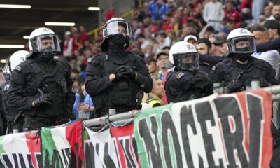 Police officers go into the crowd before the start of the Group B match between Italy and Albania at the Euro 2024 soccer tournament in Dortmund, Germany, Saturday, June 15, 2024. (AP Photo/Martin Meissner)