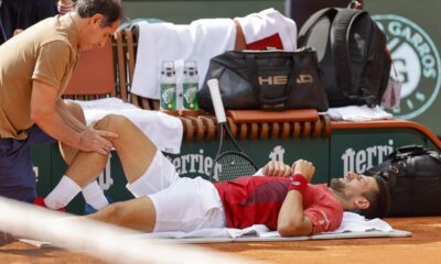 Serbia's Novak Djokovic receives medical assistance for his right knee during his fourth round match of the French Open tennis tournament against Argentina's Francisco Cerundolo at the Roland Garros stadium in Paris, Monday, June 3, 2024. (AP Photo/Jean-Francois Badias)