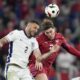 England's Kyle Walker, left, vies for a header next to Serbia's Dusan Vlahovic during the second half in a Group C match between Serbia and England at the Euro 2024 soccer tournament in Gelsenkirchen, Germany, Monday, June 17, 2024. (AP Photo/Thanassis Stavrakis)