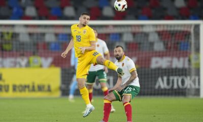 Romania's Razvan Marin hits a header next to Bulgaria's Vasil Panayotov during an international friendly soccer match between Romania and Bulgaria at the Steaua stadium in Bucharest, Romania, Tuesday, June 4, 2024.(AP Photo/Andreea Alexandru)