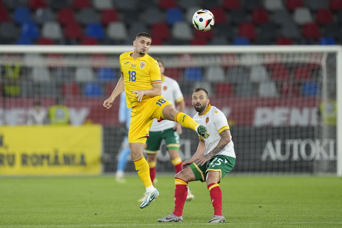 Romania's Razvan Marin hits a header next to Bulgaria's Vasil Panayotov during an international friendly soccer match between Romania and Bulgaria at the Steaua stadium in Bucharest, Romania, Tuesday, June 4, 2024.(AP Photo/Andreea Alexandru)