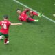 Portugal's Cristiano Ronaldo, on the ground, watches as teammate Bernardo Silva scores the opening goal during a Group F match between Turkey and Portugal at the Euro 2024 soccer tournament in Dortmund, Germany, Saturday, June 22, 2024. (AP Photo/Michael Probst)