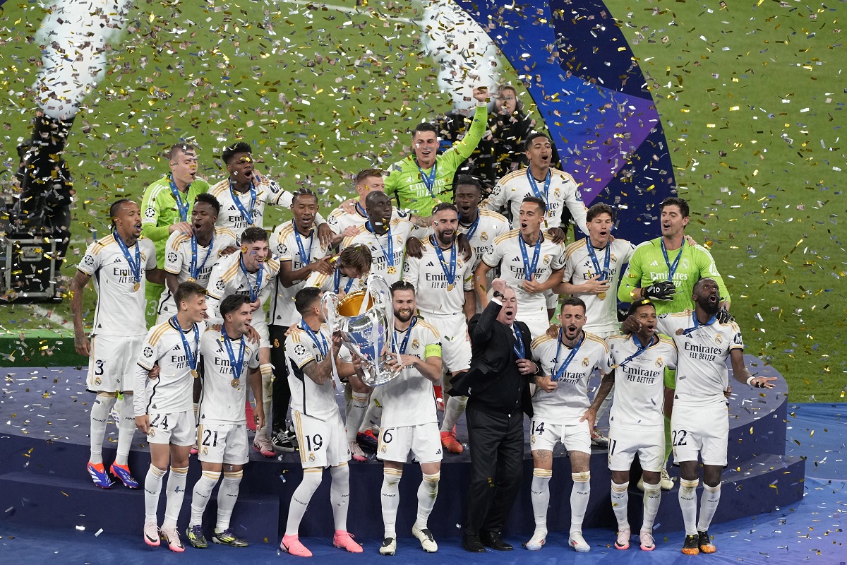 Real Madrid players celebrate with the Champions League trophy at the end of the Champions League final soccer match between Borussia Dortmund and Real Madrid at Wembley stadium in London, Saturday, June 1, 2024. Real Madrid won 2-0. (AP Photo/Alastair Grant)