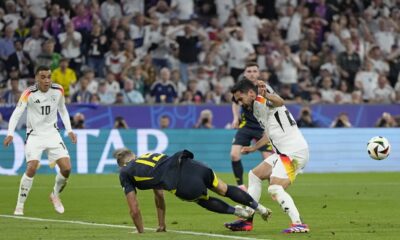 Scotland's Ryan Porteous, center left, fouls Germany's Ilkay Gundogan to give away a penalty during a Group A match between Germany and Scotland at the Euro 2024 soccer tournament in Munich, Germany, Friday, June 14, 2024. (AP Photo/Matthias Schrader)