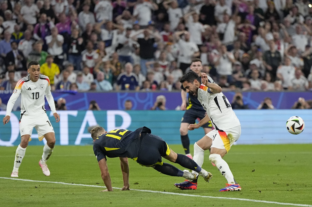 Scotland's Ryan Porteous, center left, fouls Germany's Ilkay Gundogan to give away a penalty during a Group A match between Germany and Scotland at the Euro 2024 soccer tournament in Munich, Germany, Friday, June 14, 2024. (AP Photo/Matthias Schrader)