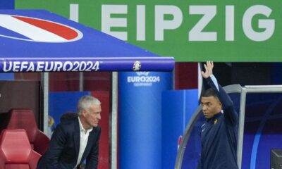 France head coach Didier Deschamps, left, looks Kylian Mbappe of France waves to supporters during a half-time of a Group D match between the Netherlands and France at the Euro 2024 soccer tournament in Leipzig, Germany, Friday, June 21, 2024. (AP Photo/Ariel Schalit)