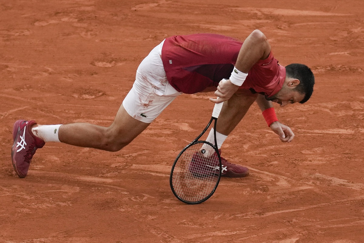 Serbia's Novak Djokovic slipped and fell during his fourth round match of the French Open tennis tournament against Argentina's Francisco Cerundolo at the Roland Garros stadium in Paris, Monday, June 3, 2024. (AP Photo/Christophe Ena)