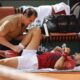 Serbia's Novak Djokovic receives medical assistance for his right knee during his fourth round match of the French Open tennis tournament against Argentina's Francisco Cerundolo at the Roland Garros stadium in Paris, Monday, June 3, 2024. (AP Photo/Jean-Francois Badias)