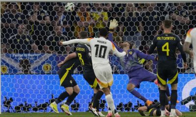 Germany's Jamal Musiala scores his side's second goal against Scotland's goalkeeper Angus Gunn during a Group A match between Germany and Scotland at the Euro 2024 soccer tournament in Munich, Germany, Friday, June 14, 2024. (AP Photo/Frank Augstein)