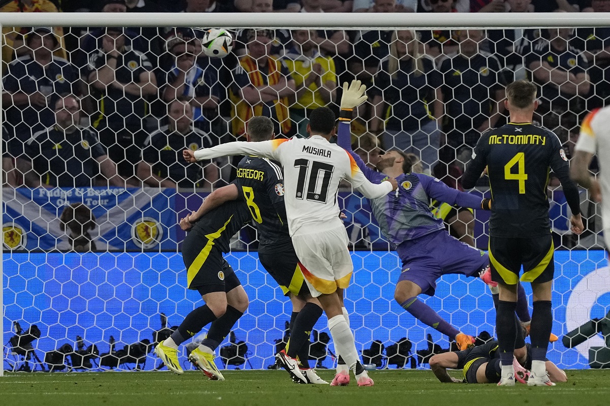 Germany's Jamal Musiala scores his side's second goal against Scotland's goalkeeper Angus Gunn during a Group A match between Germany and Scotland at the Euro 2024 soccer tournament in Munich, Germany, Friday, June 14, 2024. (AP Photo/Frank Augstein)
