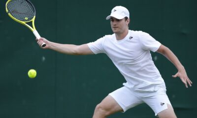 Miomir Kecmanovic of Serbia plays a forehand return to Sumit Nagal of India during their first round match of the Wimbledon tennis championships in London, Monday, July 1, 2024. (AP Photo/Kirsty Wigglesworth)