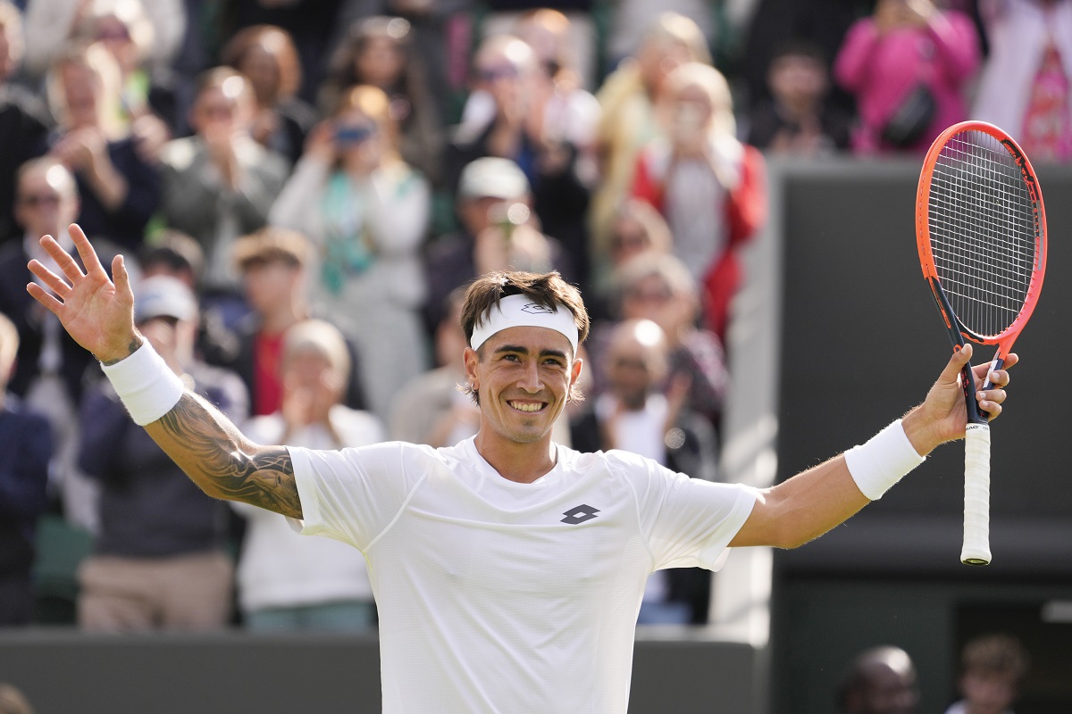 Francisco Comesana of Argentina celebrates after defeating Andrey Rublev of Russia in their first round match at the Wimbledon tennis championships in London, Tuesday, July 2, 2024. (AP Photo/Alberto Pezzali)