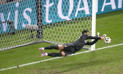 Portugal's goalkeeper Diogo Costa saves the ball during penalties of a round of sixteen match between Portugal and Slovenia at the Euro 2024 soccer tournament in Frankfurt, Germany, Monday, July 1, 2024. (AP Photo/Michael Probst)