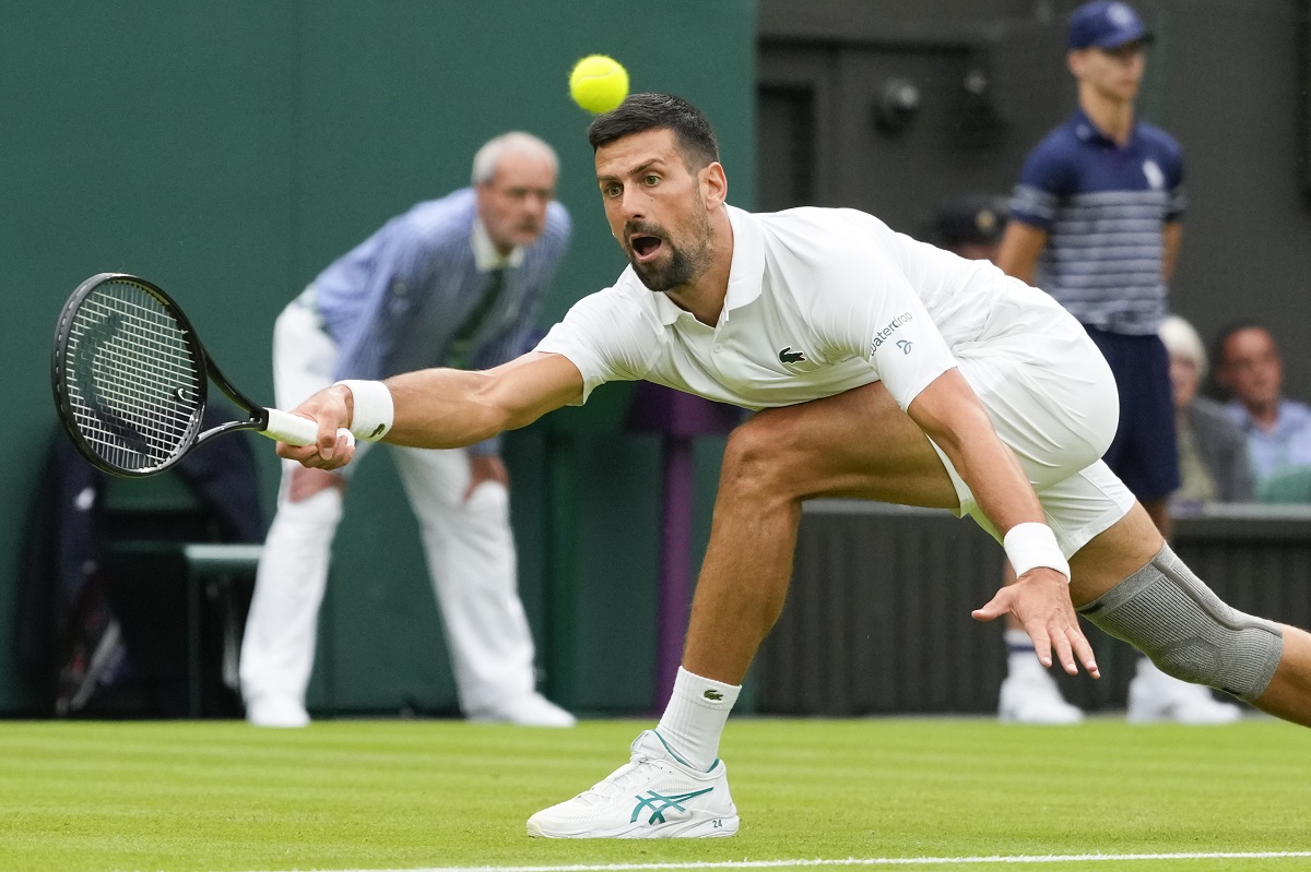 Serbia's Novak Djokovic plays a forehand return to Vit Kopriva of the Czech Republic during their first round match at the Wimbledon tennis championships in London, Tuesday, July 2, 2024. (AP Photo/Kirsty Wigglesworth)