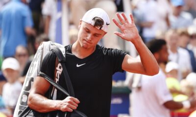 Denmark's Holger Rune looks dejected after retiring during his quarter final match against France's Arthur Fils, at the Hamburg ATP, Germany, Friday July 19, 2024. (Frank Molter/dpa via AP)