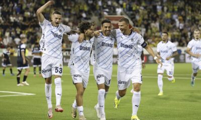 Fenerbahce players, from left, Sebastian Szymanski, Ferdi Kadioglu, Ifran Can Kahveci and Edin Dzeko celebrate after Ferdi Kadioglu scored his side's fourth goal during a UEFA Champions League qualifying second round first leg soccer match between Switzerland's FC Lugano and Turkey's Fenerbahce Istanbul at the Stockhorn Arena in Thun, Switzerland, Tuesday, July 23, 2024. (Peter Klaunzer/Keystone via AP)