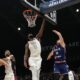 Serbia's Aleksa Avramovic, right, scores during an exhibition basketball match between Serbia and the United States at the USA Basketball Showcase, ahead of the 2024 Paris Olympic basketball tournament, in Abu Dhabi, United Arab Emirates, Wednesday, July 17, 2024. (AP Photo/Altaf Qadri)
