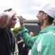 Serbia's Novak Djokovic signs a fan's forehead as he makes his way to a training session, a day ahead of his Men's singles final match against Spain's Carlos Alcaraz at the Wimbledon tennis championships, in London, Saturday, July 13, 2024. (Aaron Chown/PA via AP)