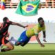 Brazil's Vinicius Junior falls as he is tackled by Colombia's Daniel Munoz during a Copa America Group D soccer match in Santa Clara, Calif., Tuesday, July 2, 2024. (AP Photo/Tony Avelar)