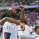 Randal Kolo Muani of France, foreground, and his teammates celebrate their side's first goal during a round of sixteen match between France and Belgium at the Euro 2024 soccer tournament in Duesseldorf, Germany, Monday, July 1, 2024. (AP Photo/Darko Vojinovic)