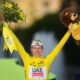 Tour de France winner Slovenia's Tadej Pogacar, wearing the overall leader's yellow jersey, celebrates on the podium after the twenty-first stage of the Tour de France cycling race, an individual time trial over 33.7 kilometers (20.9 miles) with start in Monaco and finish in Nice, France, Sunday, July 21, 2024. (AP Photo/Daniel Cole)