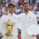 Carlos Alcaraz, left, of Spain holds his trophy after defeating Novak Djokovic, right, of Serbia in the men's singles final at the Wimbledon tennis championships in London, Sunday, July 14, 2024.(AP Photo/Kirsty Wigglesworth)
