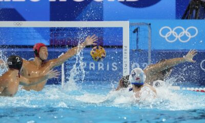 Japan's goalkeeper Towa Nishimura fails to stop a ball from Serbia's Victor Rasovic during the men's Water Polo Group B preliminary match between Serbia and Japan at the 2024 Summer Olympics, Sunday, July 28, 2024, in Saint-Denis, France. (AP Photo/Luca Bruno)