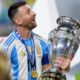 Argentina's Lionel Messi celebrates with the trophy after his team defeated Colombia in the Copa America final soccer match in Miami Gardens, Fla., Monday, July 15, 2024. (AP Photo/Rebecca Blackwell)