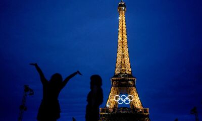 The United States' Amarilees Bolorin, left, takes a selfie with a friend in front of the Eiffel Tower ahead of the 2024 Summer Olympics, Thursday, July 25, 2024, in Paris, France. (AP Photo/Natacha Pisarenko)