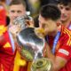 Spain's Aymeric Laporte kisses the trophy after winning the final match between Spain and England at the Euro 2024 soccer tournament in Berlin, Germany, Sunday, July 14, 2024. Spain won 2-1. (AP Photo/Manu Fernandez)
