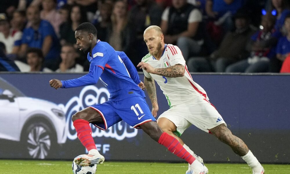 France's Ousmane Dembele runs with the ball away from Italy's Federico Dimarco, right, during the UEFA Nations League soccer match between France and Italy at the Parc des Princes in Paris, Friday, Sept. 6, 2024. (AP Photo/Michel Euler)
