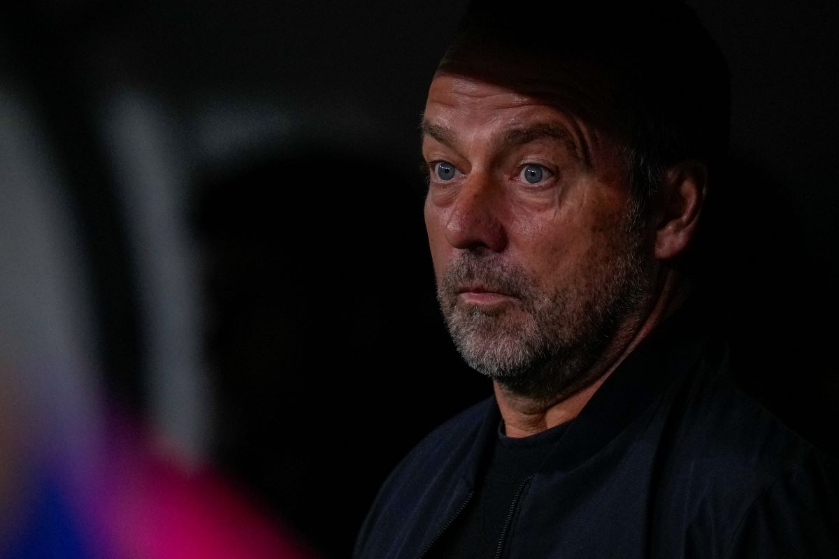 Barcelona's head coach Hansi Flick looks from the bench before a Spanish La Liga soccer match between Real Madrid and Barcelona at the Santiago Bernabeu stadium in Madrid, Spain, Saturday, Oct. 26, 2024. (AP Photo/Manu Fernandez)