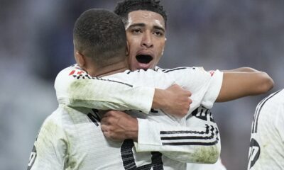 Real Madrid's Jude Bellingham, right, hugs to congratulate teammate Kylian Mbappe on scoring his side's second goal during the Spanish La Liga soccer match between Real Madrid and Getafe at the Santiago Bernabeu Stadium in Madrid, Spain, Sunday, Dec. 1, 2024. (AP Photo/Bernat Armangue)