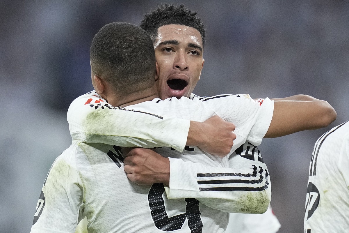 Real Madrid's Jude Bellingham, right, hugs to congratulate teammate Kylian Mbappe on scoring his side's second goal during the Spanish La Liga soccer match between Real Madrid and Getafe at the Santiago Bernabeu Stadium in Madrid, Spain, Sunday, Dec. 1, 2024. (AP Photo/Bernat Armangue)