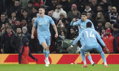 Nottingham Forest's Nikola Milenkovic (left) celebrates after scoring the opening goal during the English Premier League soccer match between Manchester United and Nottingham Forest, at Old Trafford, Manchester, England, Saturday Dec. 7, 2024. (Martin Rickett/PA via AP)