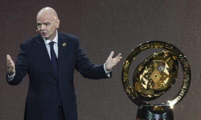 FILE - FIFA President Gianni Infantino' speaks next to the trophy during the draw for the 2025 FIFA Club World Cup soccer tournament, Thursday, Dec. 5, 2024, in Miami. (AP Photo/Rebecca Blackwell, File)