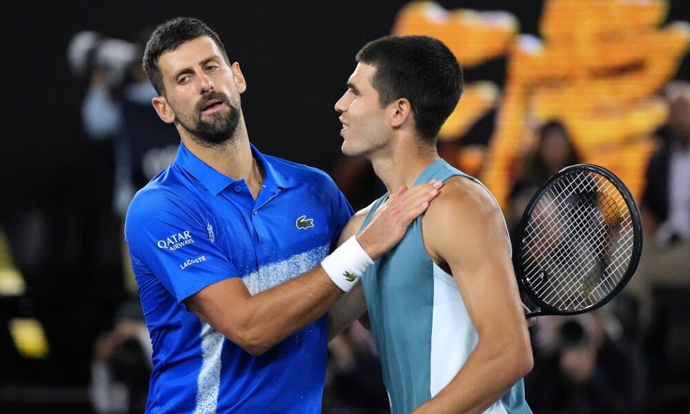 Novak Djokovic, left, of Serbia, is congratulated by Carlos Alcaraz of Spain following their quarterfinal match at the Australian Open tennis championship in Melbourne, Australia, Wednesday, Jan. 22, 2025. (AP Photo/Vincent Thian)