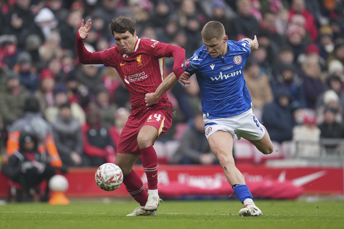 Liverpool's Federico Chiesa, left, and Accrington's Ben Woods vie for the ball during the FA Cup soccer match between Liverpool and Accrington Stanley at the Anfield stadium in Liverpool, England, Saturday, Jan. 11, 2025. (AP Photo/Jon Super)