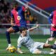 Barcelona's Lamine Yamal, left, is challenged by Alaves' Tomas Conechny during a Spanish La Liga soccer match between Barcelona and Alaves at the Lluis Companys Olympic Stadium in Barcelona, Spain, Sunday Feb. 2, 2025. (AP Photo/Joan Monfort)